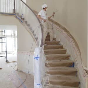Painter painting the stairs walls
